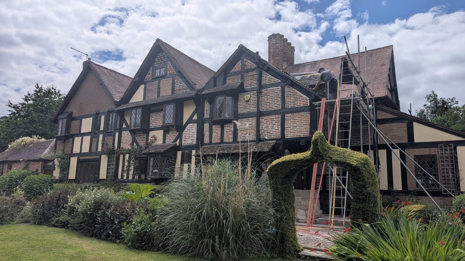 Rear elevation of the 16th Century timber-framed listed property in Barnt Green with scaffolding erected for heritage roof restoration