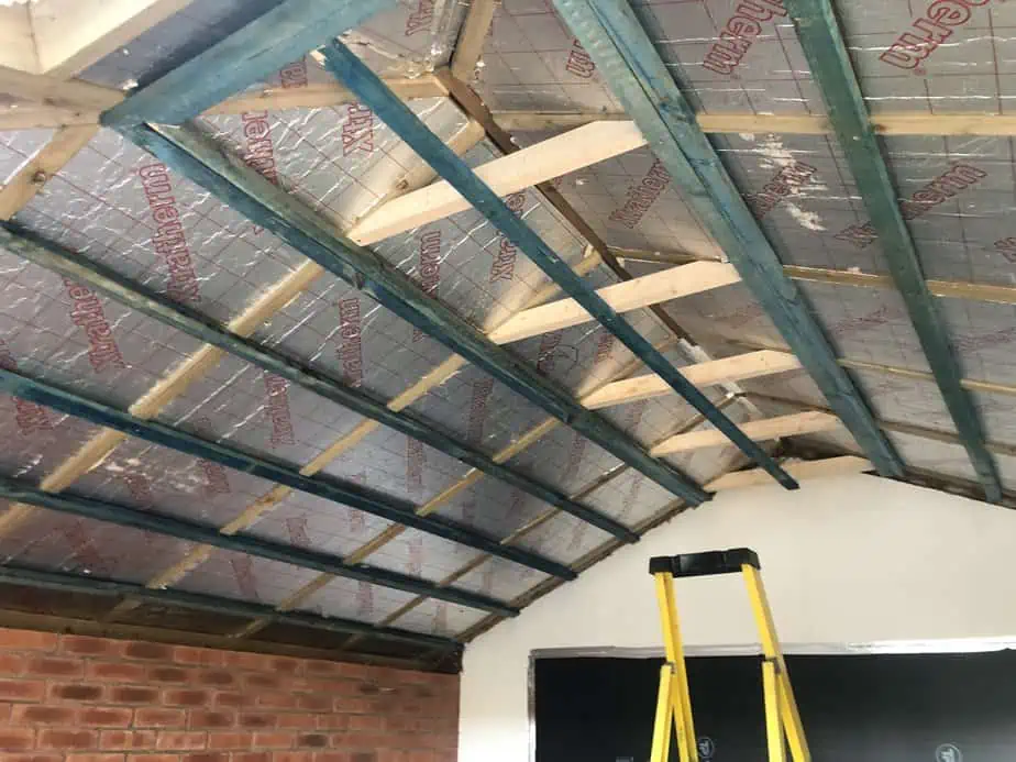 PIR insulation fitted between the timber rafters during a warm conservatory roof conversion