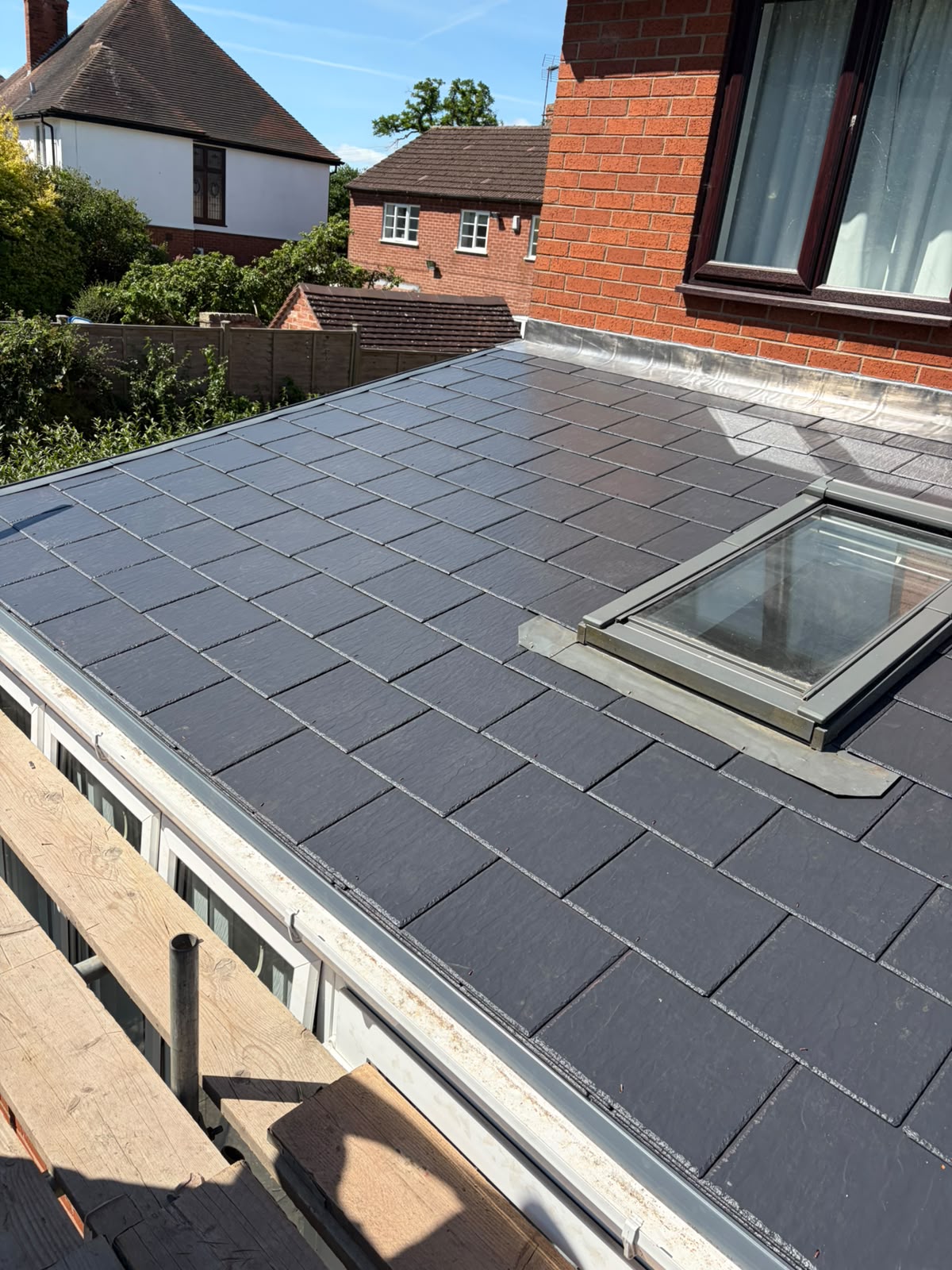 Completed synthetic slate conservatory roof with Velux window